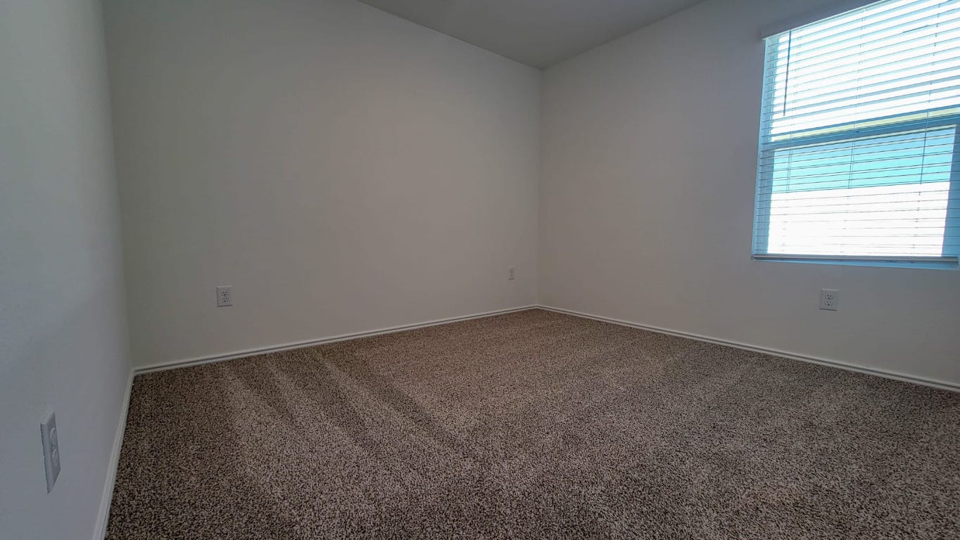 245 Texoma Street Kyle, TX 78640 - Photo 12 of 17 an empty room with a window