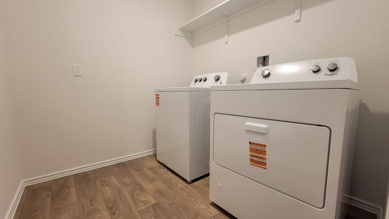 245 Texoma Street Kyle, TX 78640 - Photo 14 of 17 a utility room with dryer and washer