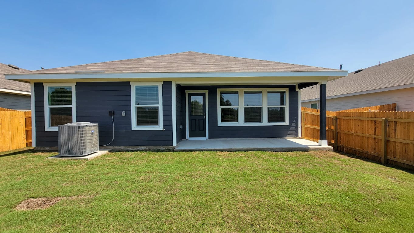 245 Texoma Street Kyle, TX 78640 - Photo 17 of 17 a view of an house with backyard and porch
