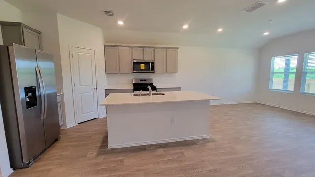 a room with cabinets and a refrigerator