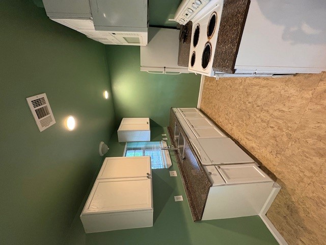 606 Guadalimar Street Lockhart, TX 78644 - Photo 4 of 11 a kitchen with stainless steel appliances granite countertop a sink stove and refrigerator