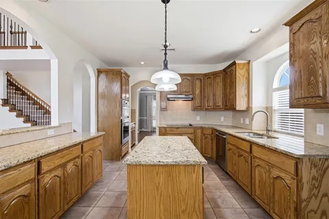 a kitchen with a stove and a refrigerator