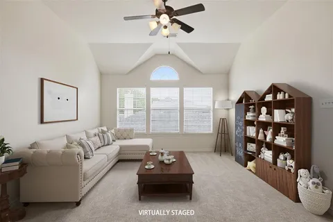 an empty room with a chandelier fan and windows