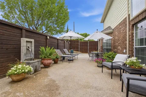 an aerial view of a house with garden space and street view