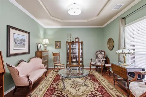 a living room with furniture large window and fireplace