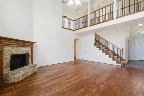 a kitchen with stainless steel appliances granite countertop hardwood a sink refrigerator and cabinets