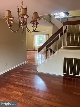 a view of a room with wooden floor and staircase
