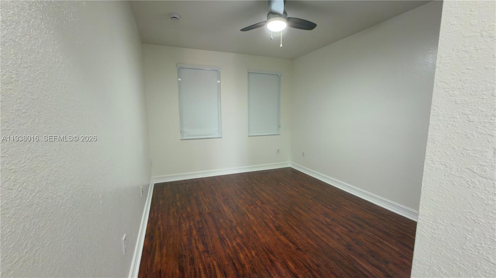 7633 Northwest 114th Path, Unit 7633 Doral, FL 33178 - Photo 22 of 30 an empty room with wooden floor and windows