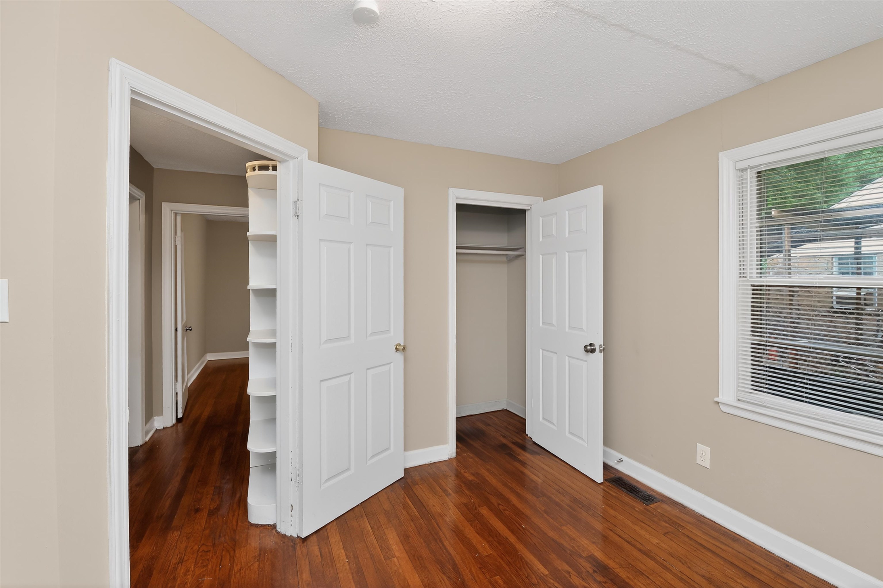 2840 Allen Road Memphis, TN 38128 - Photo 25 of 31 Room featuring wood-finish flooring, neutral wall paint, and white trim