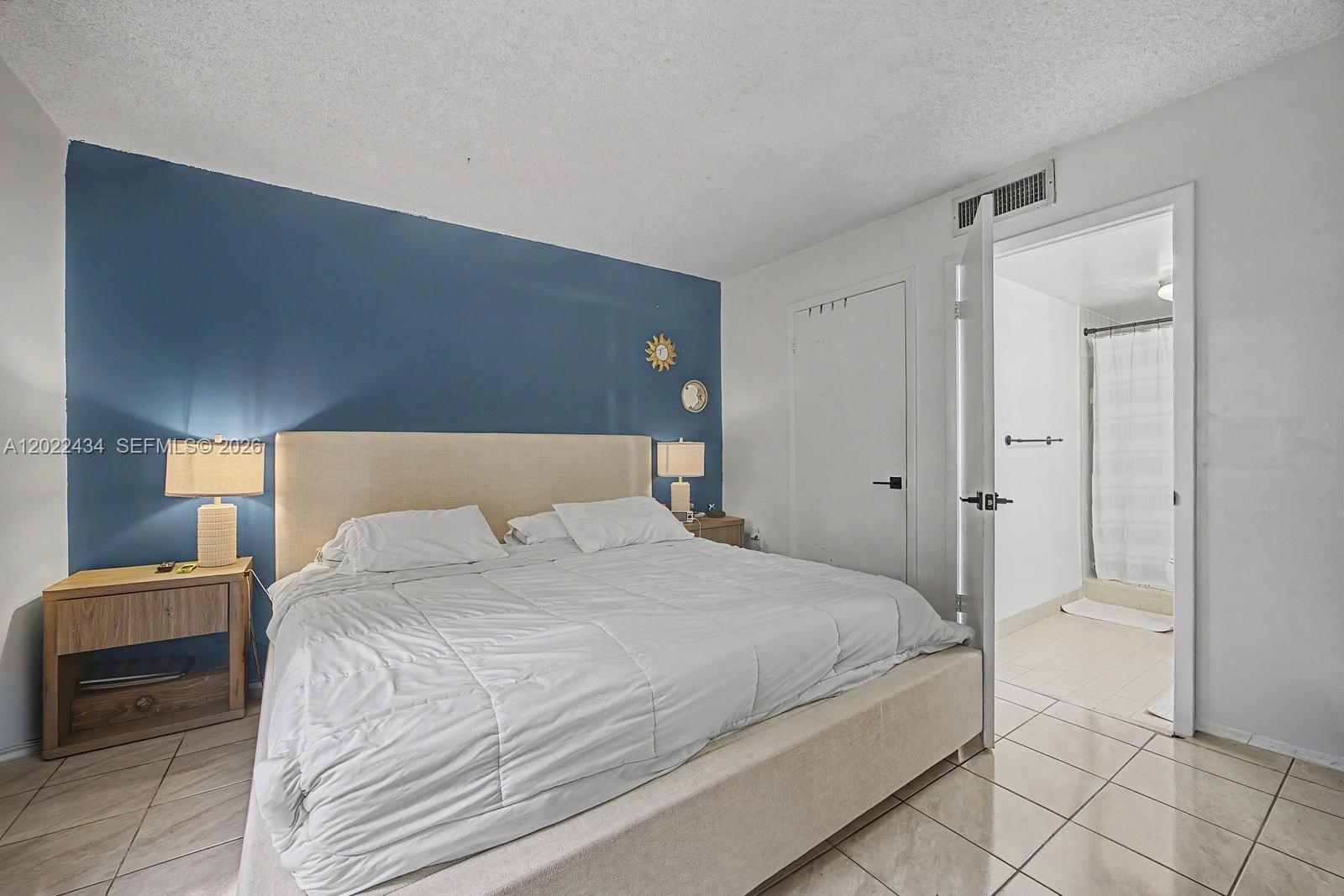 13045 Southwest 68th Street, Unit 111 Miami, FL 33183 - Photo 9 of 15 a bedroom with a bed and a closet