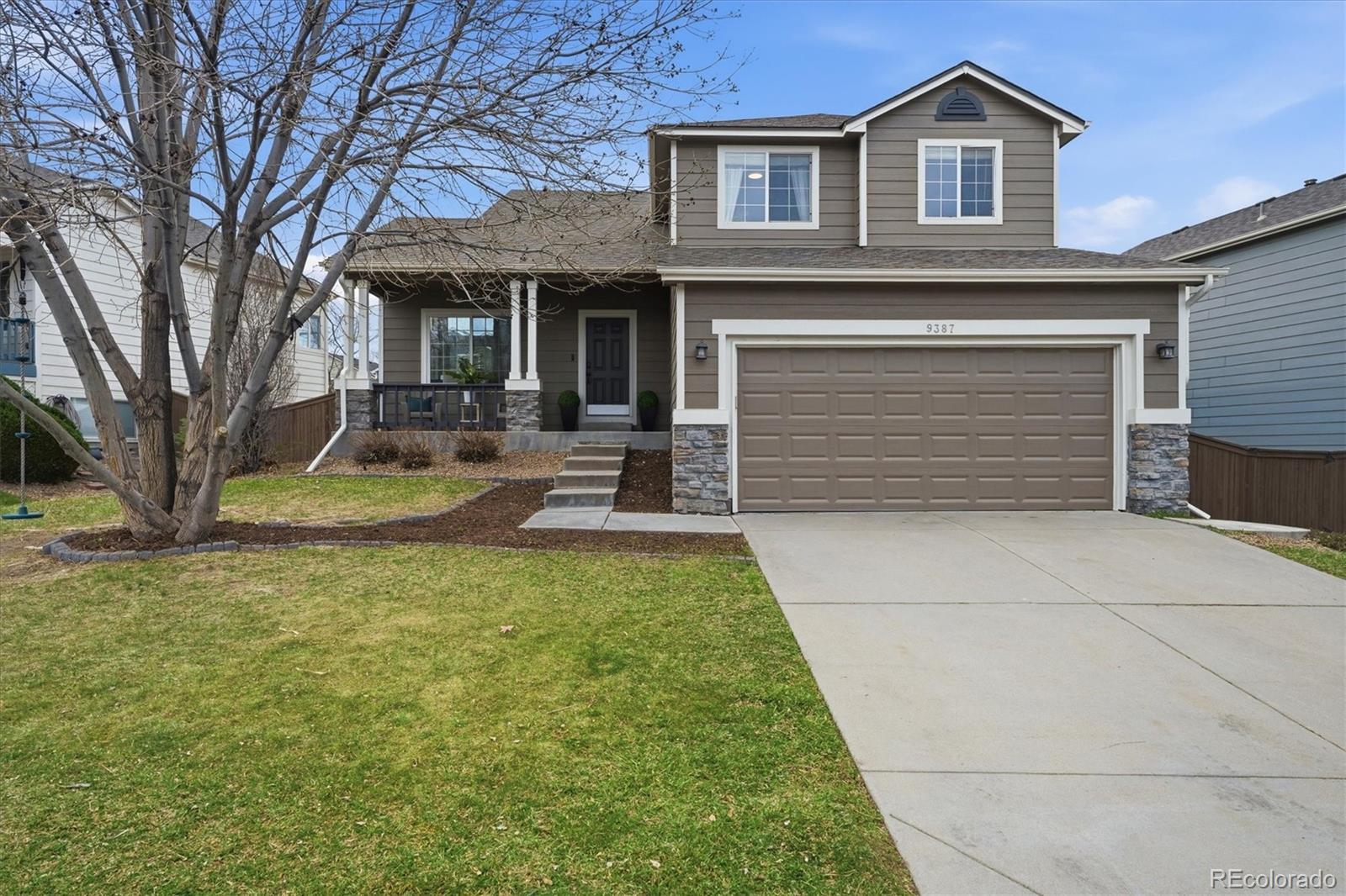 9387 Wolfe Drive Highlands Ranch, CO 80129 - Photo 1 of 50 a front view of a house with garden