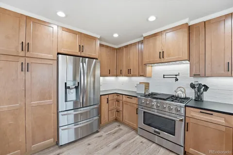 a kitchen with a refrigerator stove and cabinets