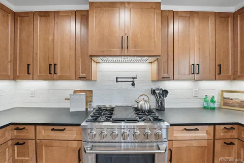 a kitchen with a stove and cabinets