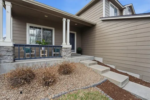 a view of a house with backyard and sitting area