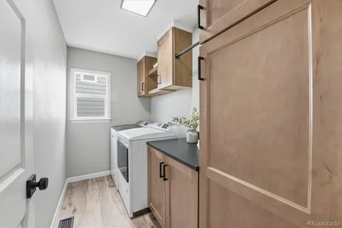 a utility room with cabinets washer and dryer