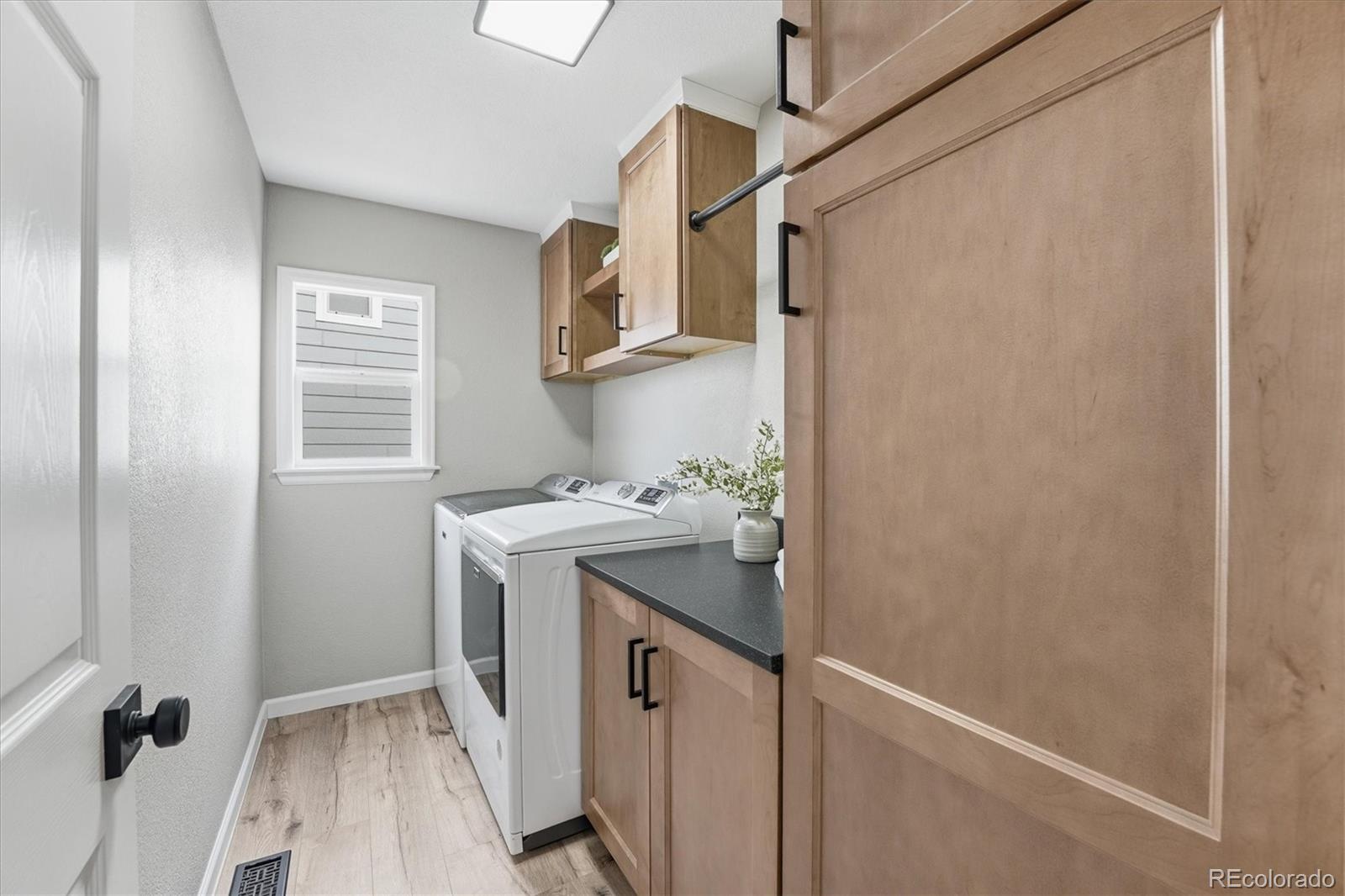 9387 Wolfe Drive Highlands Ranch, CO 80129 - Photo 26 of 50 a utility room with cabinets washer and dryer