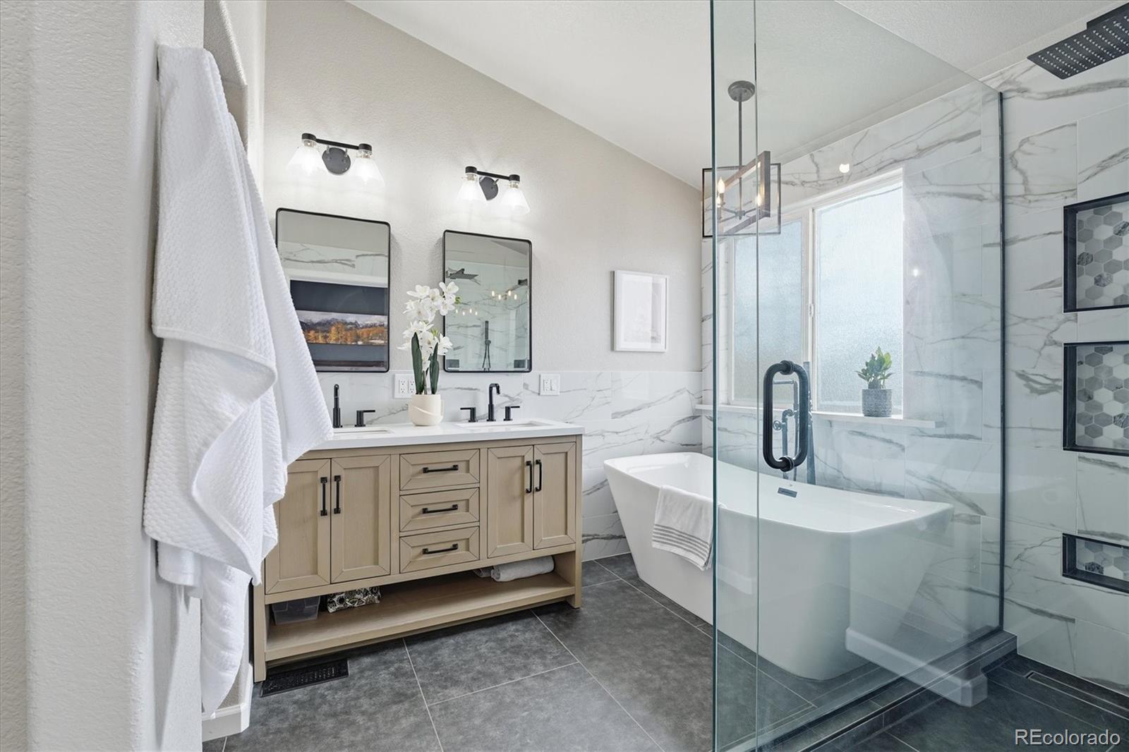 9387 Wolfe Drive Highlands Ranch, CO 80129 - Photo 31 of 50 a bathroom with a double vanity sink a mirror and shower
