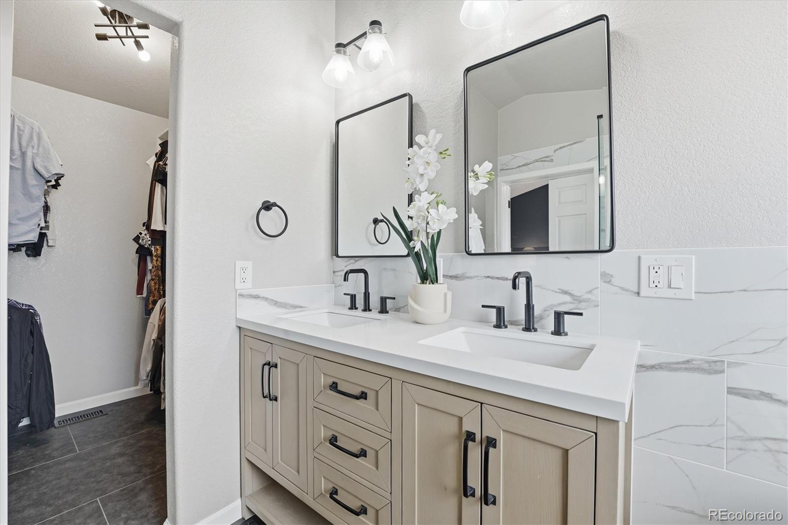 9387 Wolfe Drive Highlands Ranch, CO 80129 - Photo 33 of 50 a bathroom with a double vanity sink mirror and