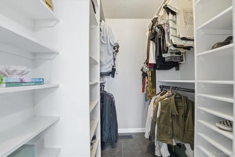 a bedroom with a bed mirror and a window