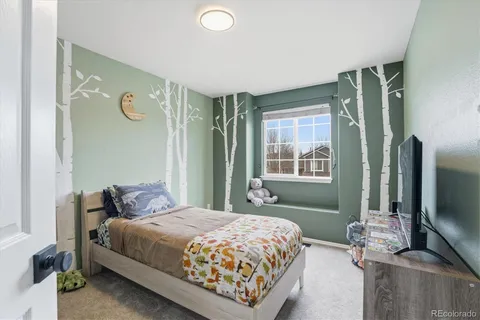 a bedroom with a bed and a mirror