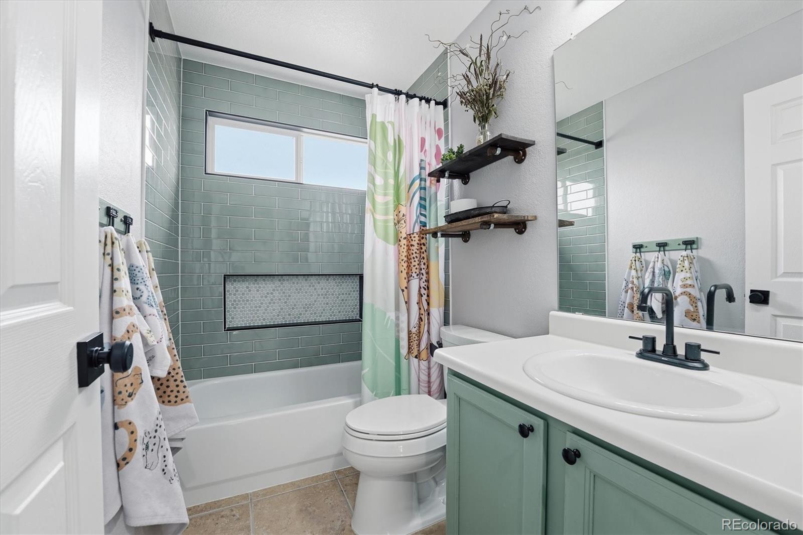 9387 Wolfe Drive Highlands Ranch, CO 80129 - Photo 38 of 50 a bathroom with a sink toilet and shower