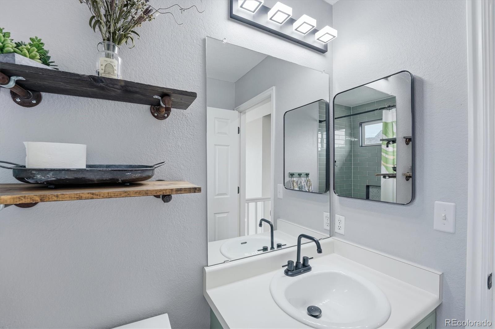 9387 Wolfe Drive Highlands Ranch, CO 80129 - Photo 40 of 50 a bathroom with a sink and a mirror