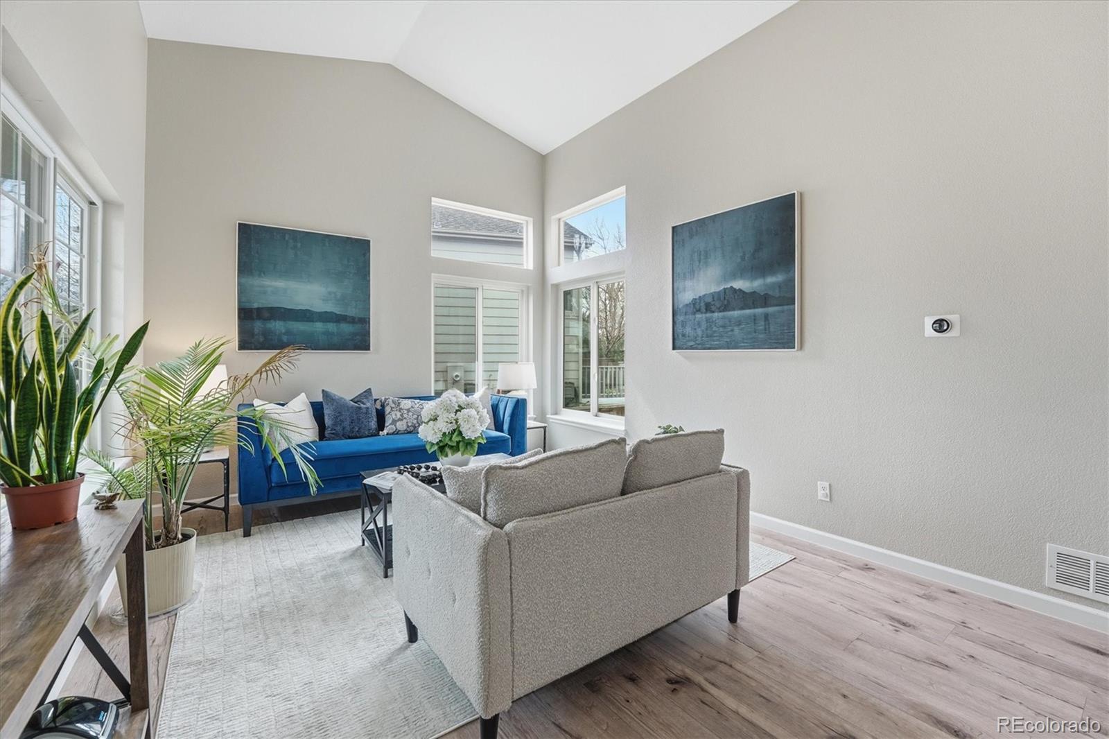 9387 Wolfe Drive Highlands Ranch, CO 80129 - Photo 4 of 50 a living room with furniture and a potted plant