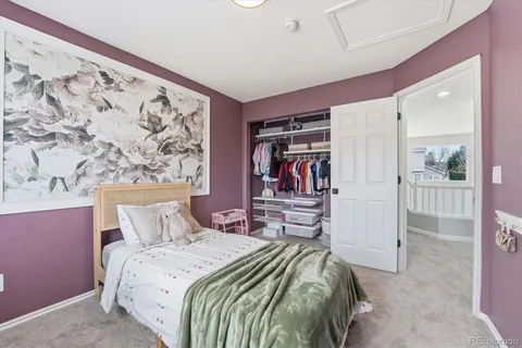 a bedroom with a bed and a mirror