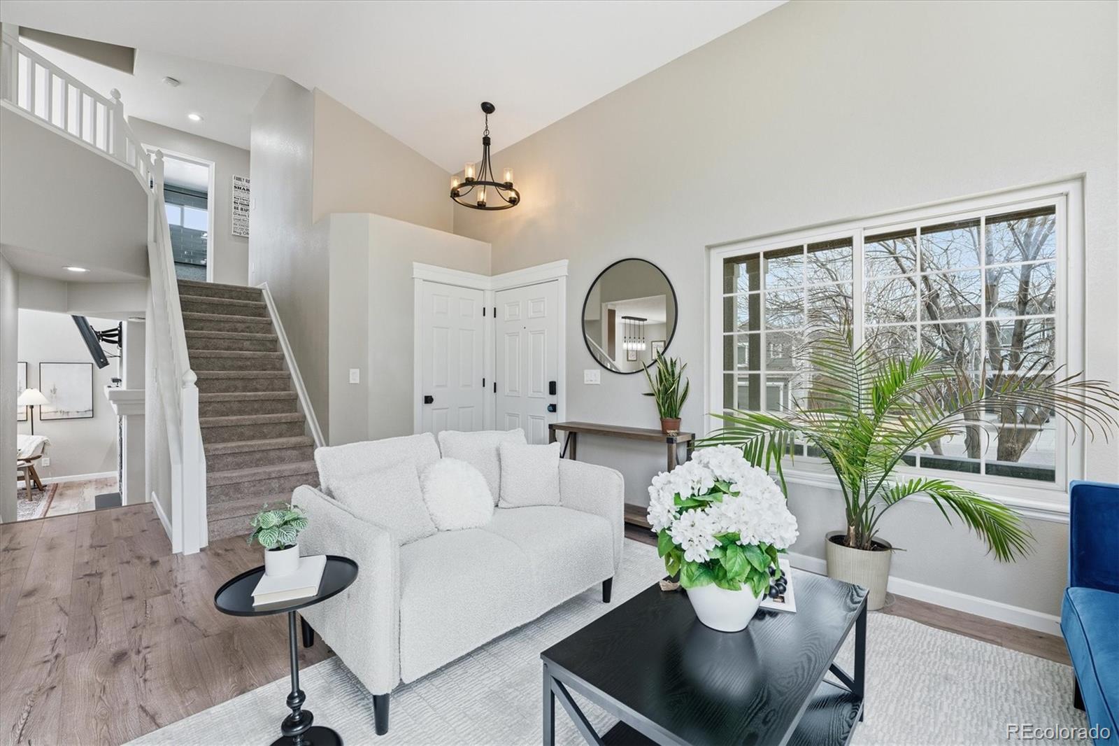 9387 Wolfe Drive Highlands Ranch, CO 80129 - Photo 5 of 50 a living room with furniture potted plant and a window