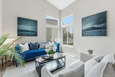 a living room with furniture and a potted plant