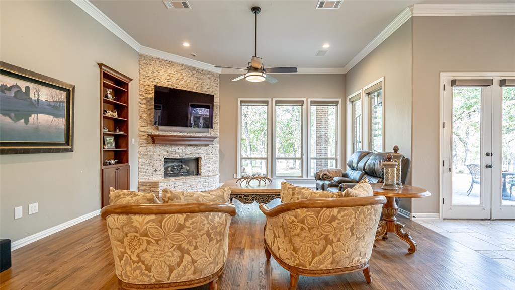 400 Porter Road Bartonville, TX 76226 - Photo 12 of 40 a living room with fireplace furniture flat screen tv and wooden floor