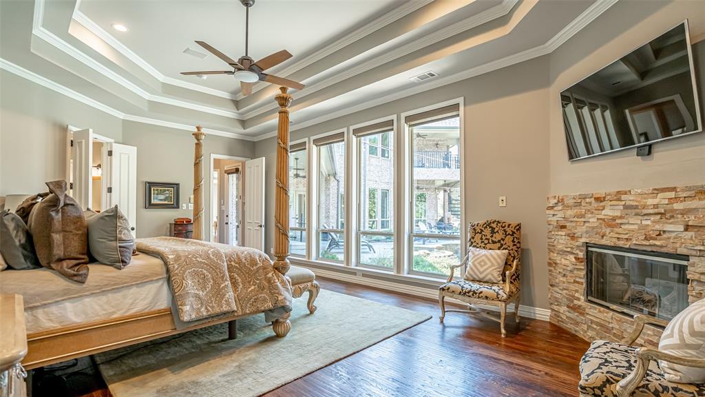 400 Porter Road Bartonville, TX 76226 - Photo 14 of 40 a bedroom with a bed a chandelier and flat screen tv