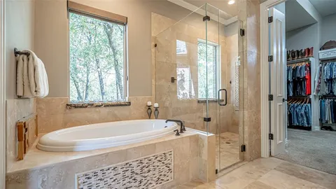 a bathroom with a tub and a shower