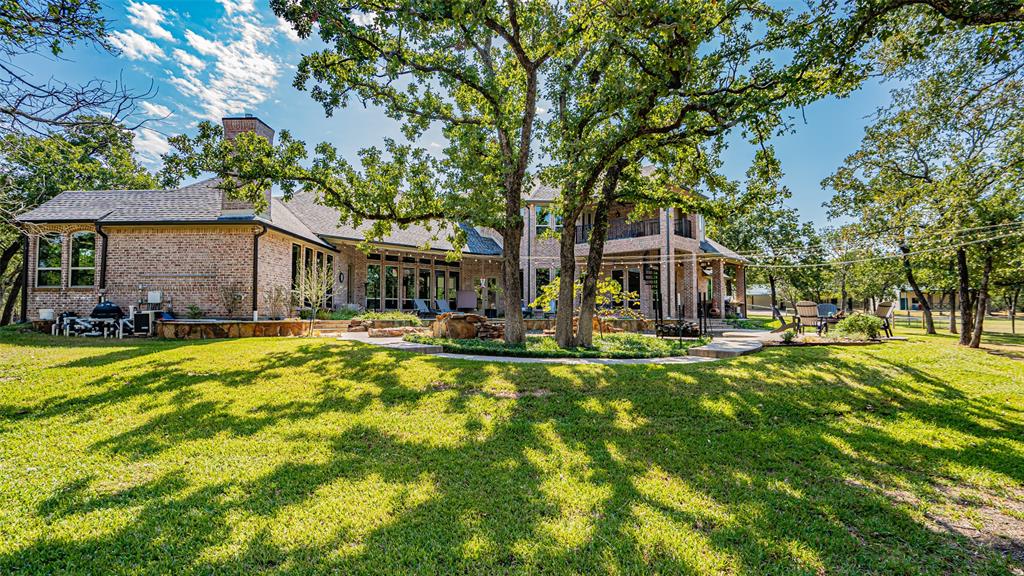 400 Porter Road Bartonville, TX 76226 - Photo 24 of 40 a front view of a house with swimming pool having outdoor seating