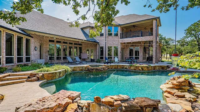 a view of house with swimming pool yard and outdoor seating