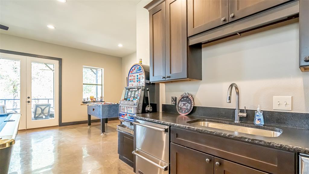 400 Porter Road Bartonville, TX 76226 - Photo 33 of 40 a kitchen with a sink and a stove top oven