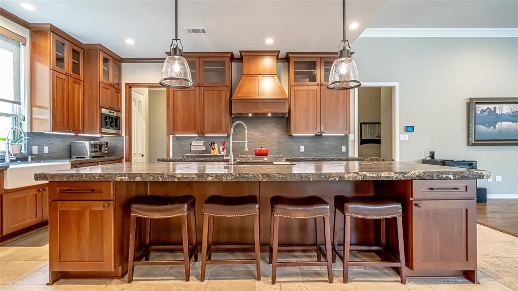 400 Porter Road Bartonville, TX 76226 - Photo 7 of 40 a kitchen with stainless steel appliances granite countertop a sink and chairs
