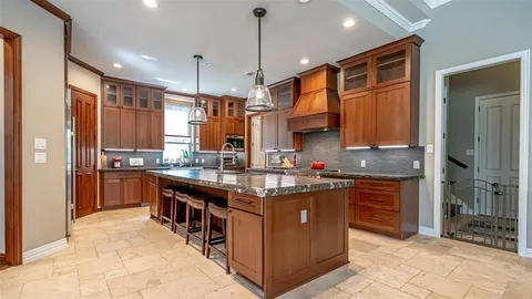 a kitchen with stainless steel appliances granite countertop a stove a sink dishwasher a refrigerator and a oven