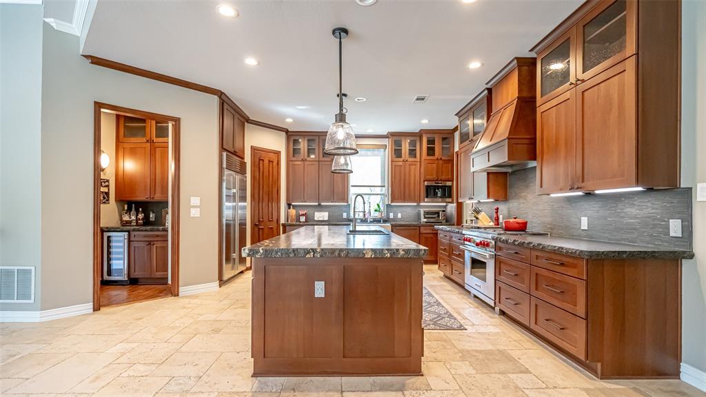 400 Porter Road Bartonville, TX 76226 - Photo 9 of 40 a kitchen with stainless steel appliances granite countertop a stove top oven a refrigerator a sink and dishwasher