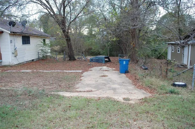 a view of a outdoor space with deck and tree