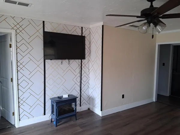 a view of a room with wooden floor and windows
