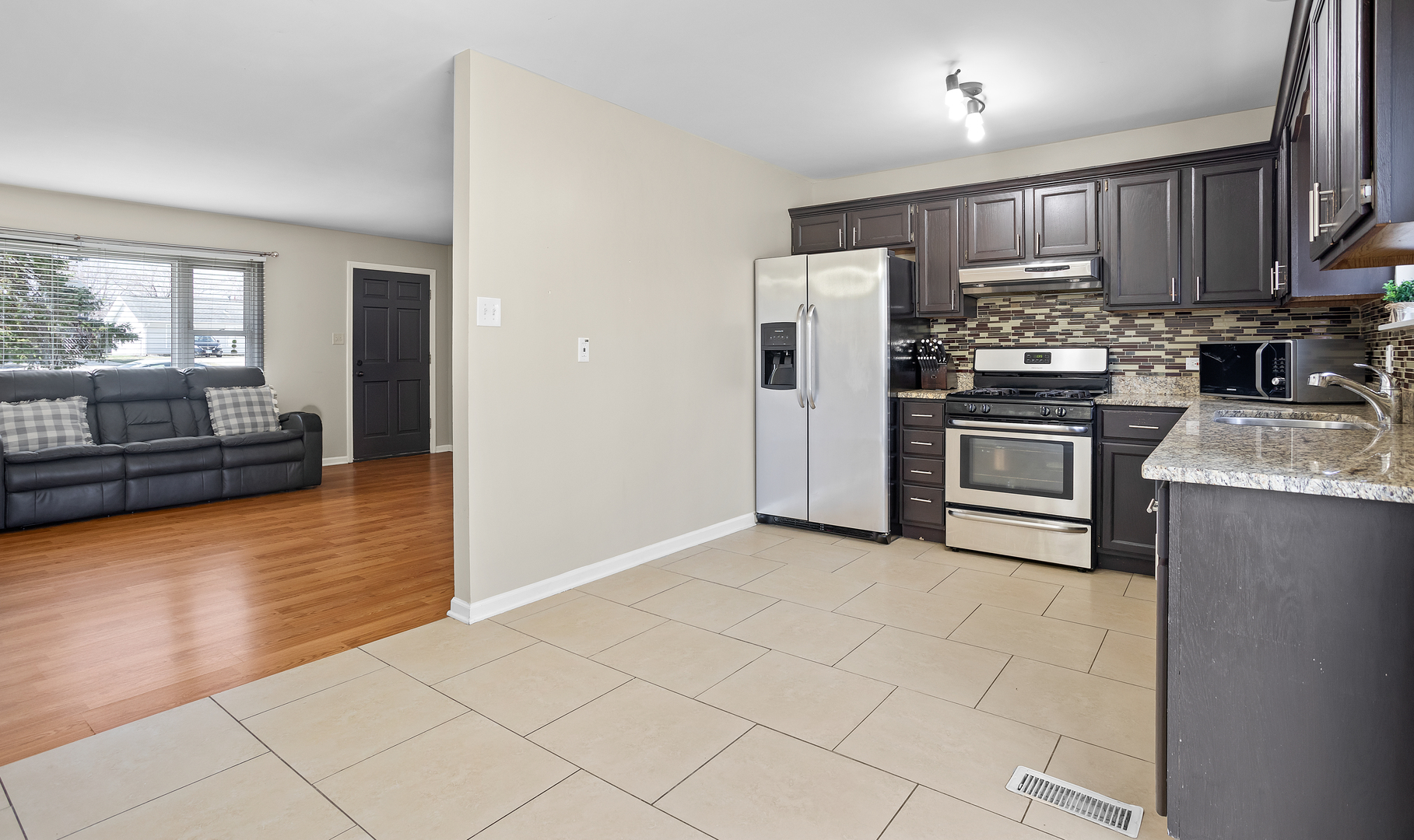 206 Seabury Road Bolingbrook, IL 60440 - Photo 6 of 16 a kitchen with granite countertop a refrigerator and a stove top oven