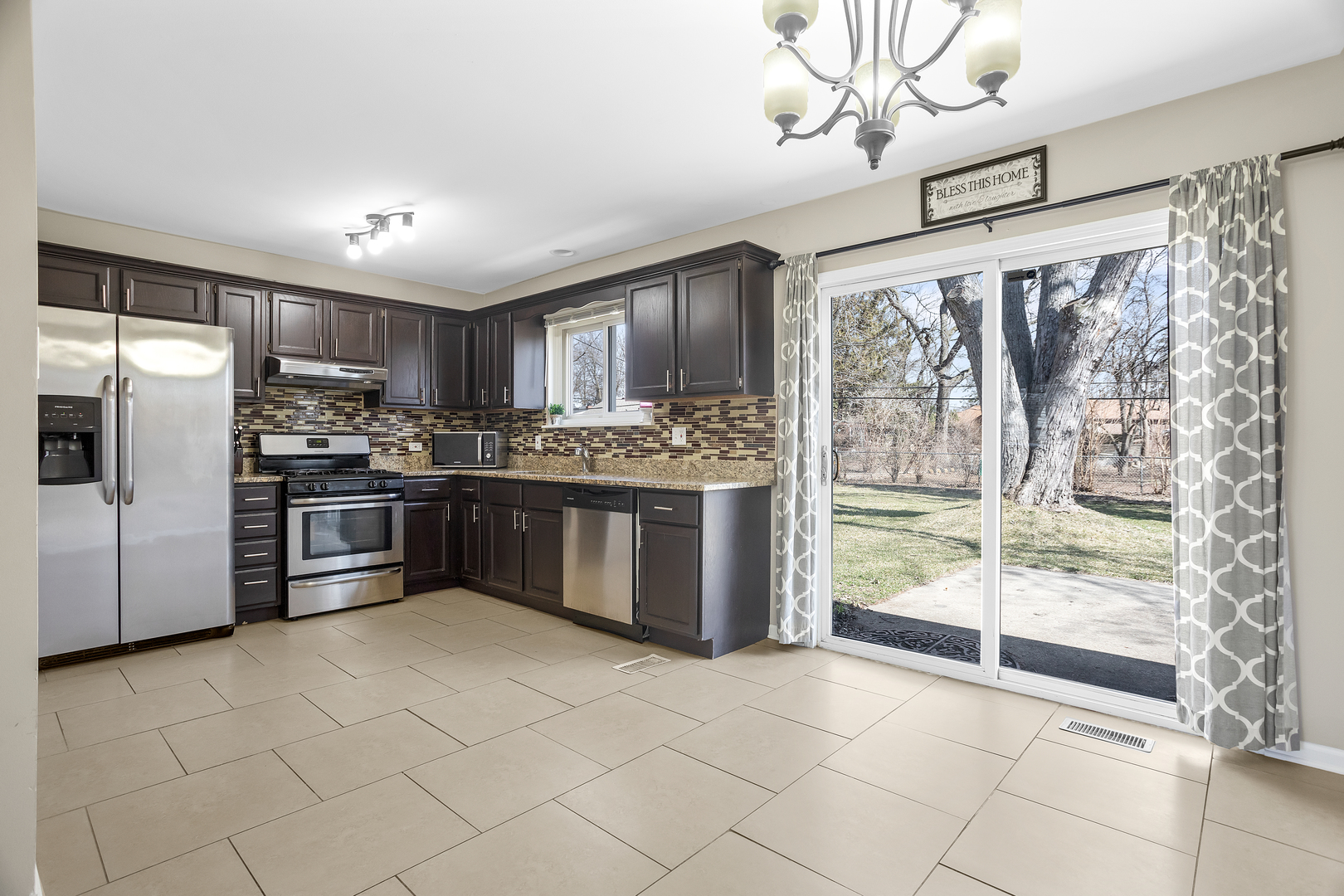 206 Seabury Road Bolingbrook, IL 60440 - Photo 7 of 16 a kitchen with stainless steel appliances granite countertop a stove a sink and a refrigerator