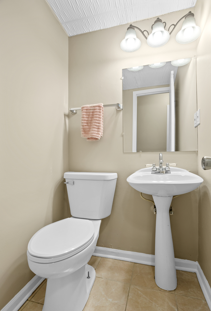 206 Seabury Road Bolingbrook, IL 60440 - Photo 10 of 16 a bathroom with a toilet sink and mirror