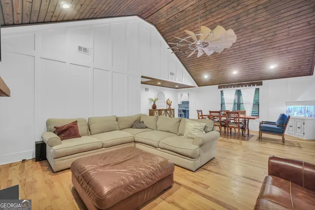 a kitchen with a table chairs and a wooden floor