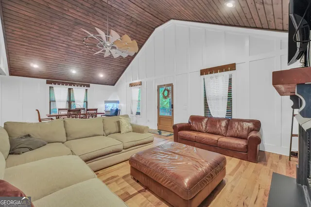 a living room with fireplace furniture and a wooden floor