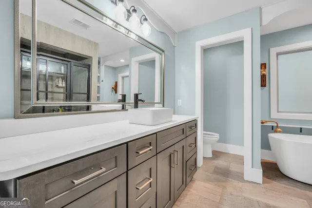 a view of a patio with table and chairs potted plants and a palm tree