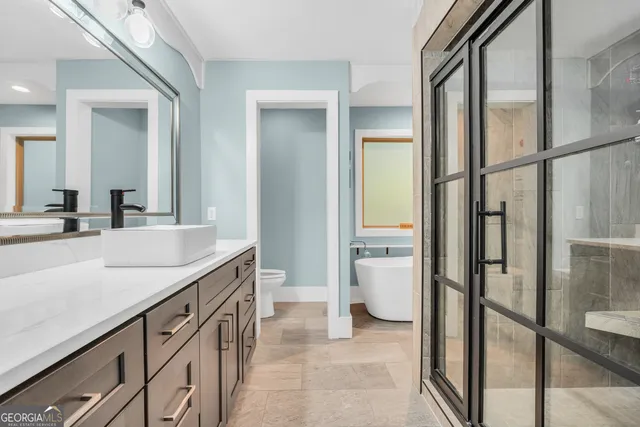 a living room with furniture a window and a flat screen tv