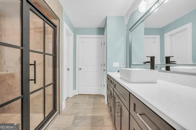 a living room with furniture kitchen view and a wooden floor