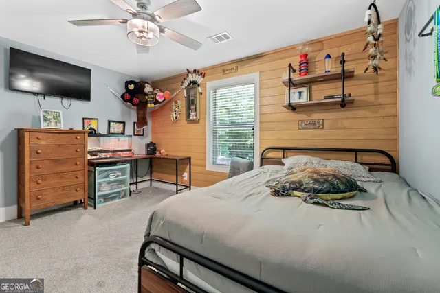 a bathroom with a granite countertop toilet a sink and a mirror